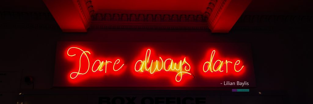 Dare always dare - Lilian Baylis quote in red neon light